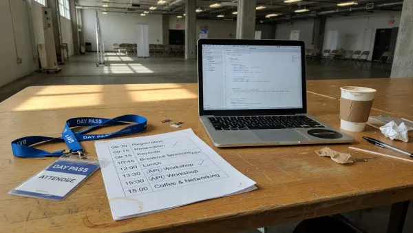 Printed FastAPI Conf one-day schedule on a desk next to a laptop showing an OpenAPI JSON file, desk lamp, no logos